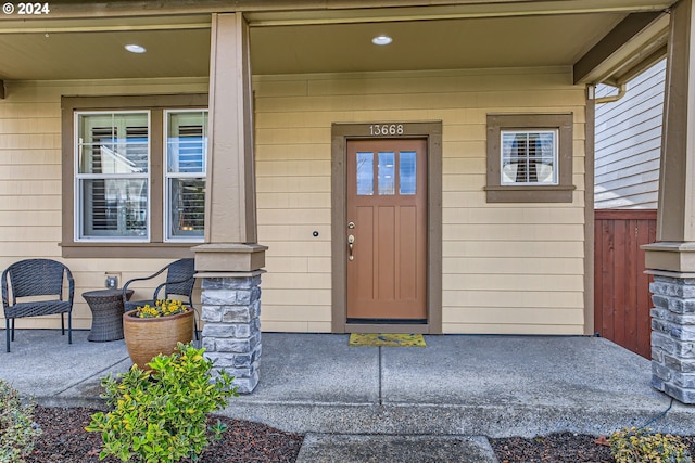 view of exterior entry with a porch