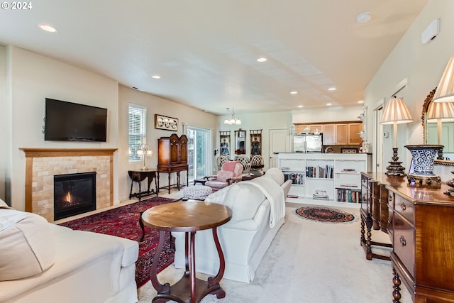 carpeted living room featuring an inviting chandelier