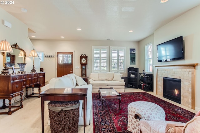 living room with a fireplace and light carpet