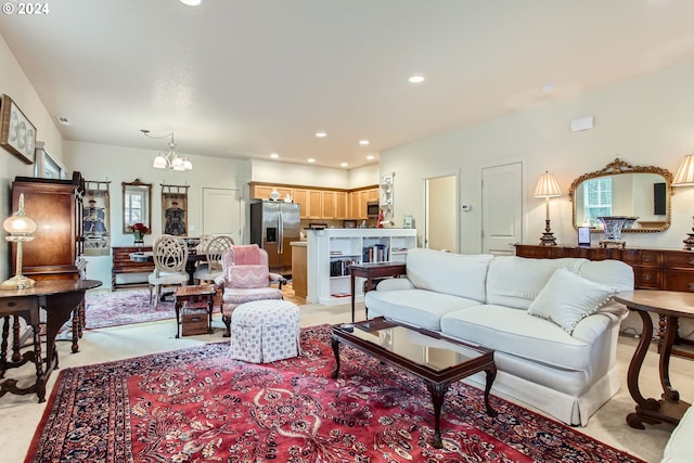 carpeted living room with a notable chandelier