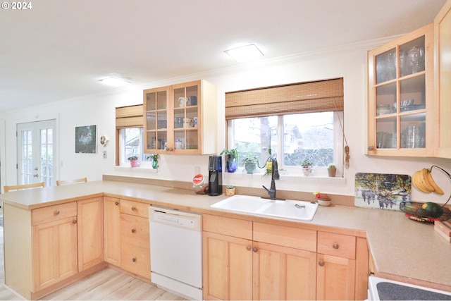 kitchen with crown molding, kitchen peninsula, light brown cabinetry, dishwasher, and sink