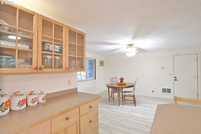 kitchen featuring light hardwood / wood-style flooring, light brown cabinetry, and ceiling fan