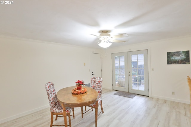 dining area featuring ornamental molding, light hardwood / wood-style floors, and french doors