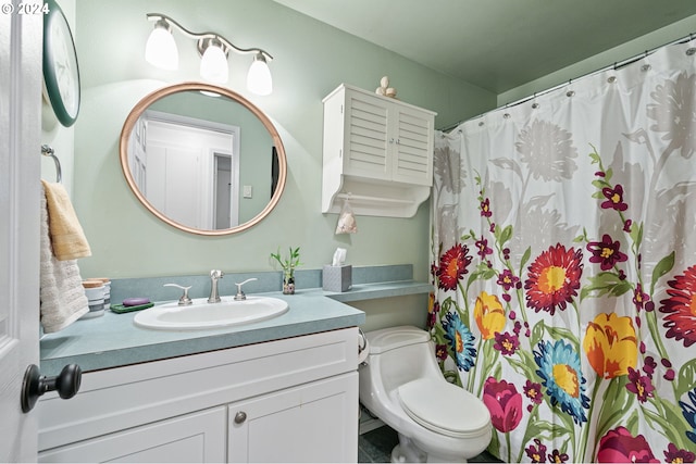 bathroom featuring toilet and vanity