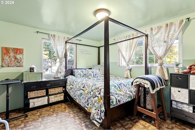 bedroom featuring parquet flooring