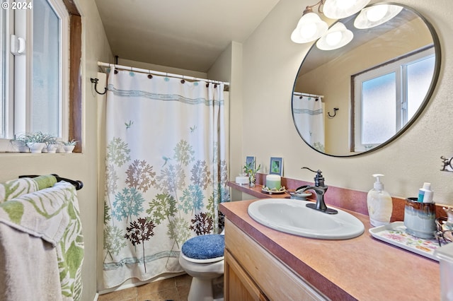 bathroom featuring tile patterned flooring, toilet, a notable chandelier, vanity, and a shower with shower curtain