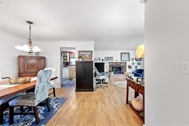 office with an inviting chandelier, light hardwood / wood-style flooring, a fireplace, and crown molding