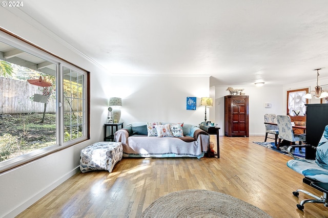 bedroom with ceiling fan with notable chandelier, crown molding, and hardwood / wood-style floors