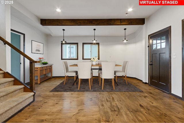 dining room featuring beamed ceiling and wood-type flooring