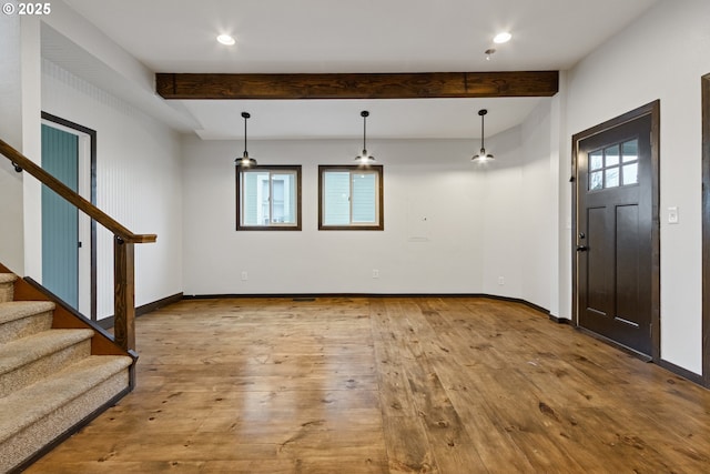 entrance foyer with light wood-type flooring and beamed ceiling