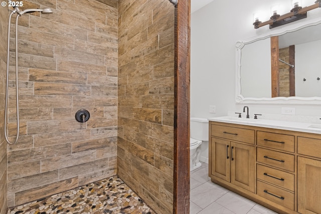 bathroom featuring tiled shower, vanity, and toilet