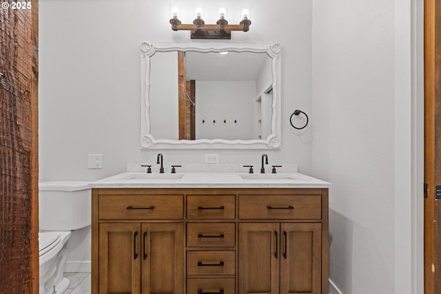 bathroom featuring toilet and vanity