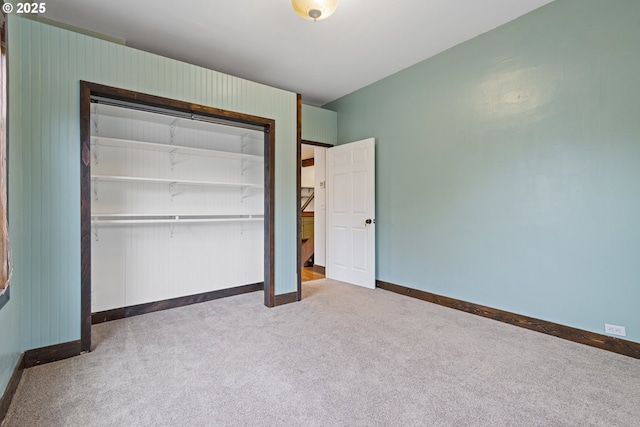 unfurnished bedroom with a closet and carpet flooring