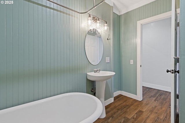 bathroom with sink, hardwood / wood-style flooring, and a tub