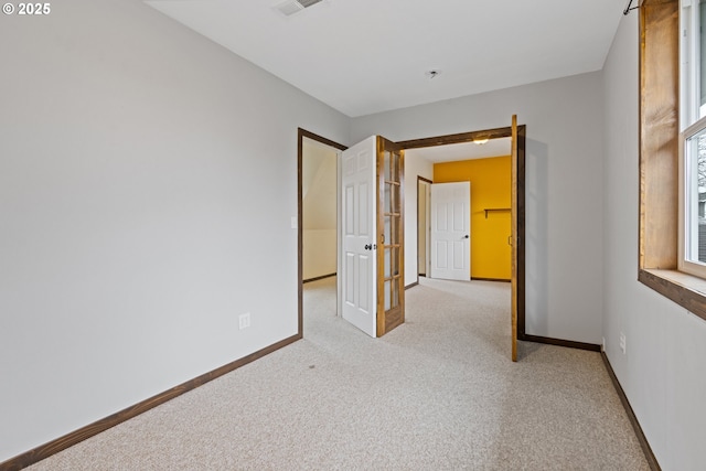 unfurnished bedroom featuring light carpet