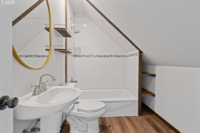 full bathroom with toilet, tiled shower / bath combo, sink, and hardwood / wood-style floors