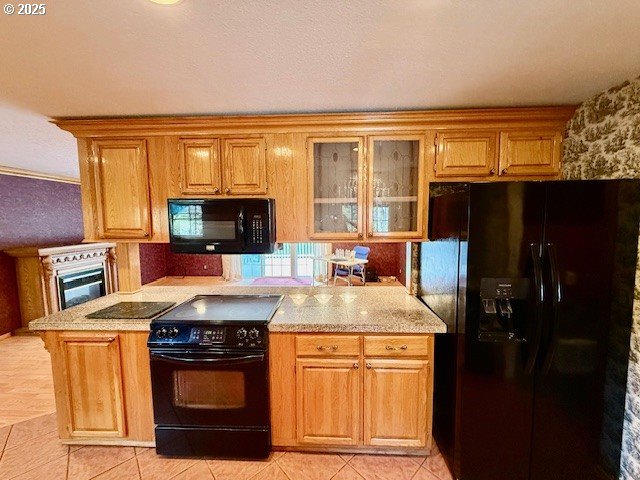 94504 Smokey Ln, Coquille, OR 97423 - kitchen with brown cabinetry, light tile patterned flooring, glass insert cabinets, and black appliances