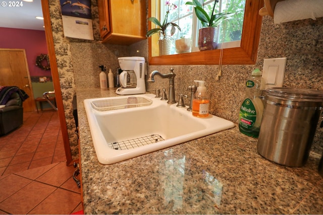 kitchen with backsplash, tile patterned floors, and sink