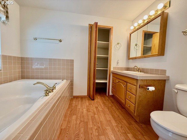 94504 Smokey Ln, Coquille, OR 97423 - full bath with toilet, wood finished floors, vanity, and a garden tub