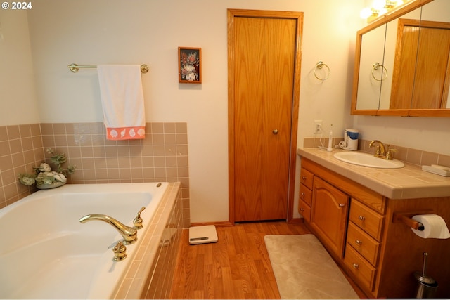 94504 Smokey Ln, Coquille, OR 97423 - bathroom with wood finished floors, vanity, and a garden tub