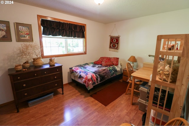 bedroom with hardwood / wood-style flooring