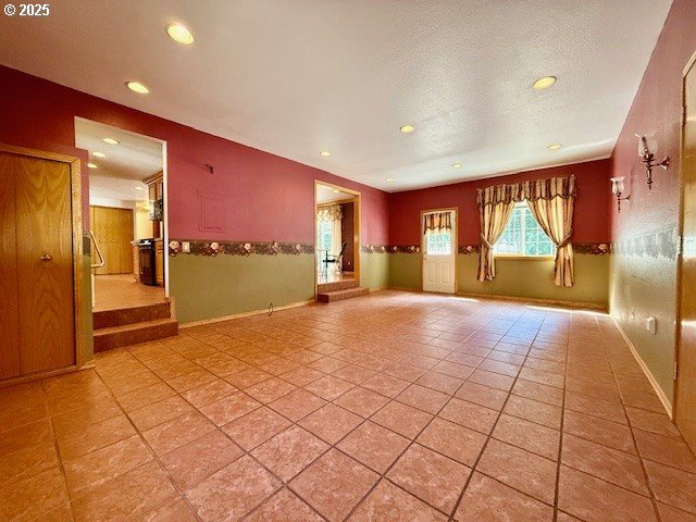 94504 Smokey Ln, Coquille, OR 97423 - tiled spare room featuring a textured ceiling, baseboards, and recessed lighting