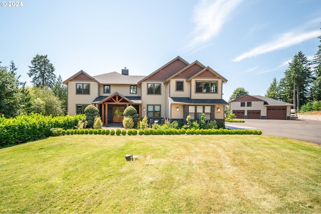 craftsman house with a front yard and a garage