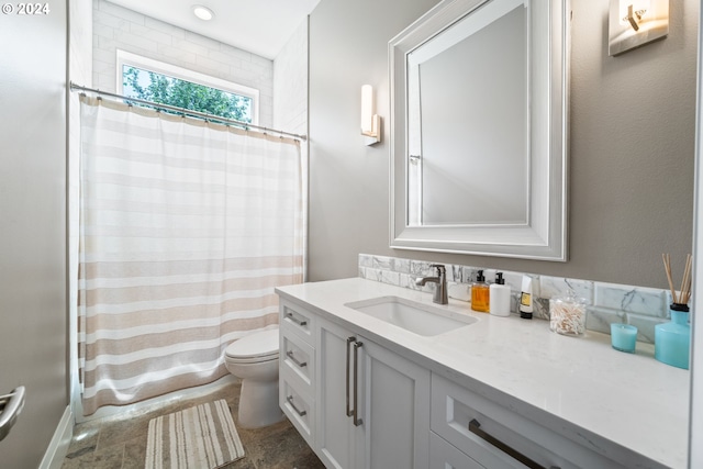 bathroom with toilet and vanity