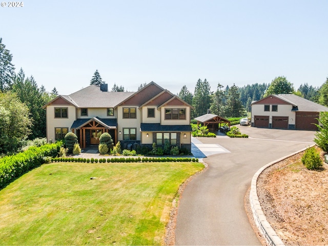 view of front of property featuring a garage, a carport, and a front yard