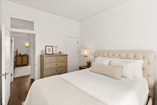 bedroom featuring dark hardwood / wood-style floors and crown molding