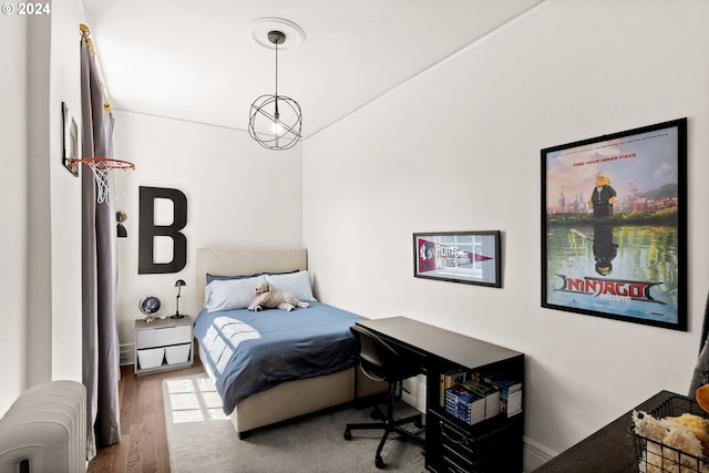 bedroom featuring wood-type flooring and radiator