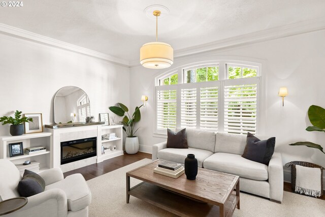 living room with hardwood / wood-style flooring and ornamental molding