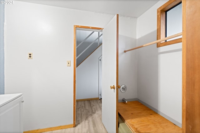 laundry area featuring light wood-type flooring