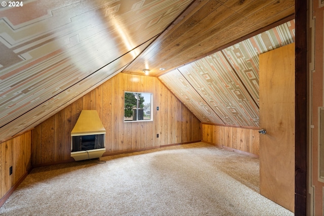 additional living space featuring wooden ceiling, light carpet, wooden walls, and vaulted ceiling