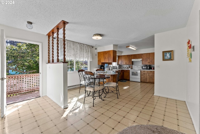 kitchen featuring a textured ceiling and white electric range