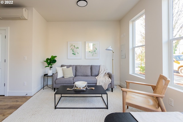 living room featuring hardwood / wood-style floors and an AC wall unit