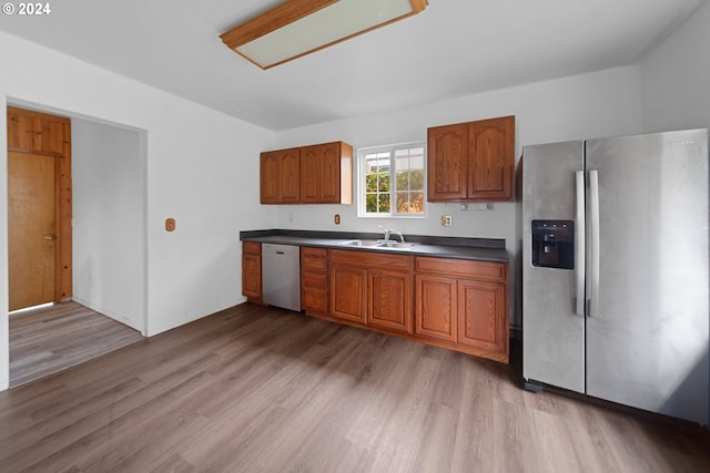 kitchen featuring hardwood / wood-style flooring, sink, and appliances with stainless steel finishes