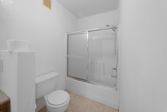 bathroom featuring toilet and enclosed tub / shower combo