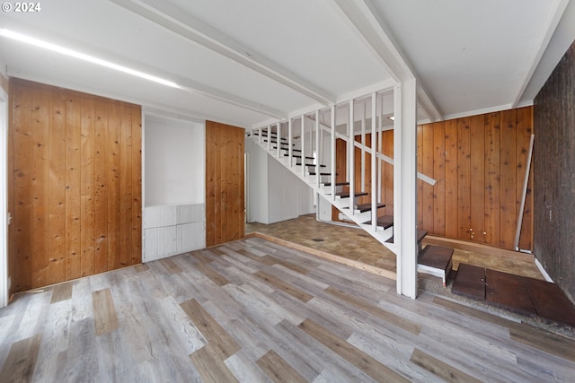 interior space with wood walls and light wood-type flooring