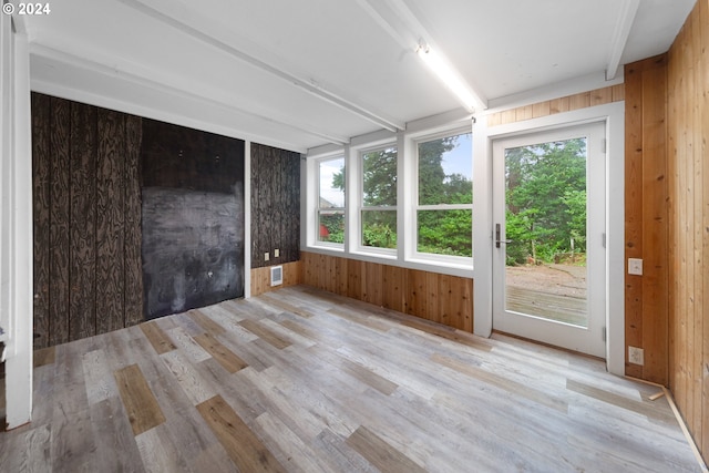 unfurnished sunroom with beam ceiling