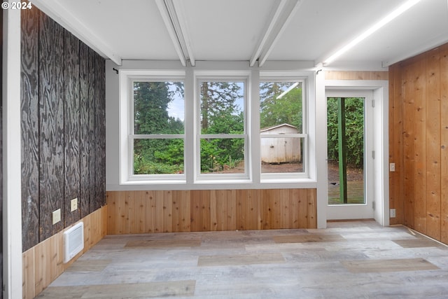 unfurnished sunroom with beam ceiling