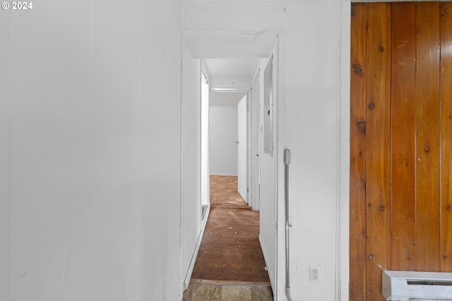 hallway with wooden walls and dark hardwood / wood-style flooring