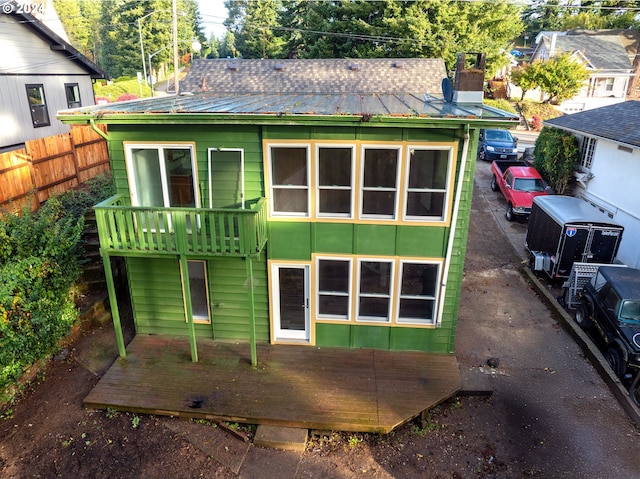 1381 Central Ave, Coos Bay, OR 97420 - back of house featuring fence, metal roof, a wooden deck, and a chimney
