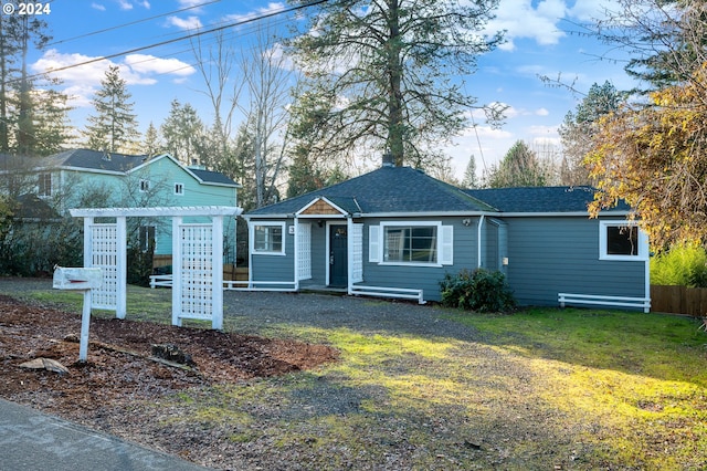 view of front of house featuring a front yard and a pergola