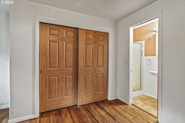 unfurnished bedroom featuring a closet and hardwood / wood-style flooring