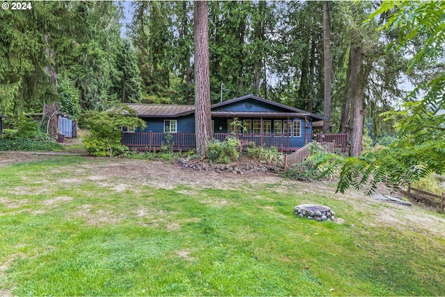 exterior space with a deck and a front yard