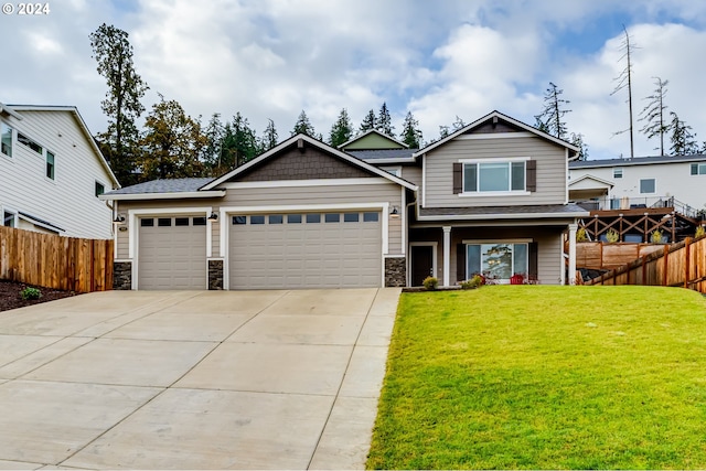 craftsman inspired home with a garage and a front yard