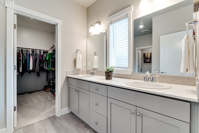 bathroom with hardwood / wood-style flooring, vanity, and decorative backsplash