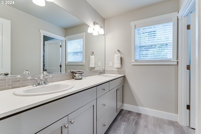 bathroom with vanity, tasteful backsplash, and wood-type flooring