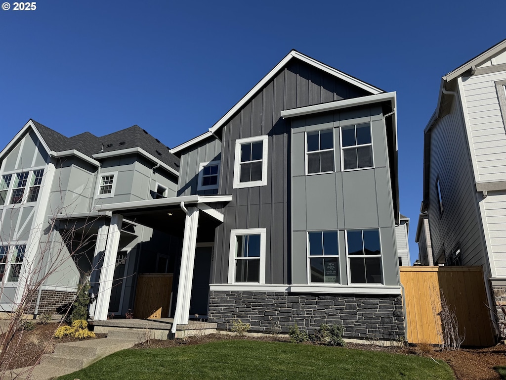 view of front of house featuring stone siding and board and batten siding